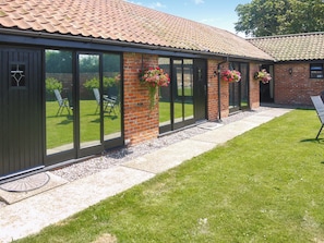 A building with large windows, a brick facade, and a tiled roof. - Barn Owl Lodge 1 - UK51444 (Corton)