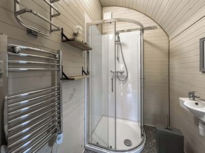 A shower with a glass door, a towel rack, and a sink. - Spruce Pod - UK51539 (Newton Stewart)