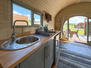 A kitchen with a sink, stove, and window. - Spruce Pod - UK51539 (Newton Stewart)