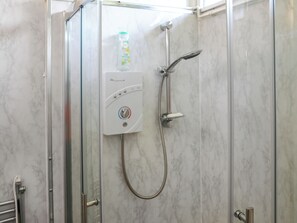 A glass-enclosed shower with a handheld showerhead and a wall-mounted control panel. - 2 bedroom accommodation in Newcastle Emlyn (Newcastle Emlyn)