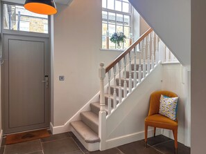 A staircase with white balusters, a wooden handrail, and a carpeted landing. - West House - UK51668 (Leyburn)