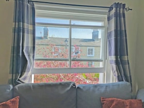 A room with a window, curtains, and a sofa. - 1 bedroom accommodation in Royal Wootton Bassett (Royal Wootton Bassett)
