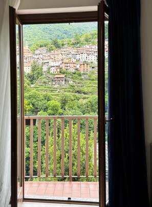 A balcony with a view of a hillside town. - Casa Adri (Molina)