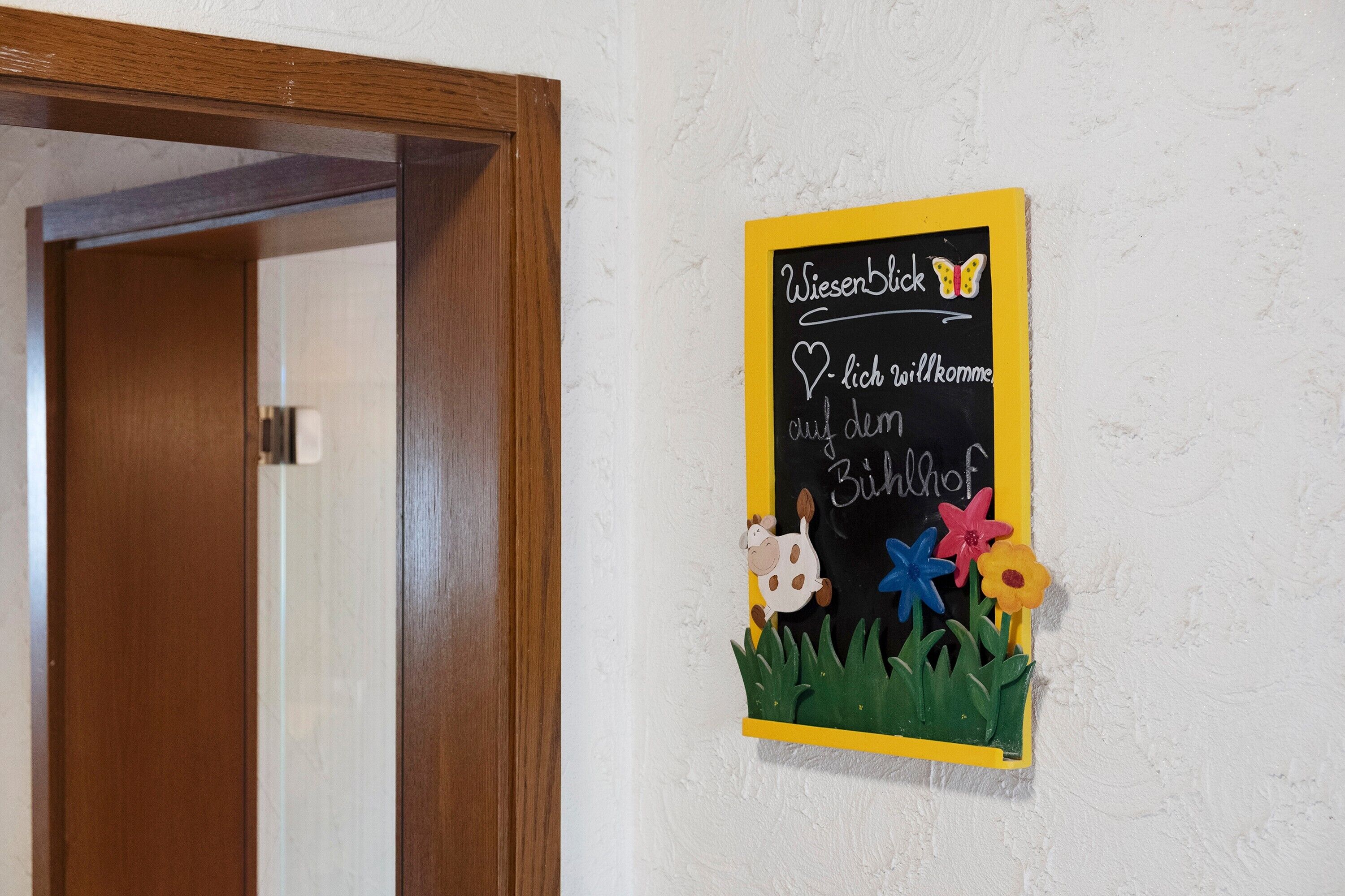 A chalkboard with a message and a cow illustration.