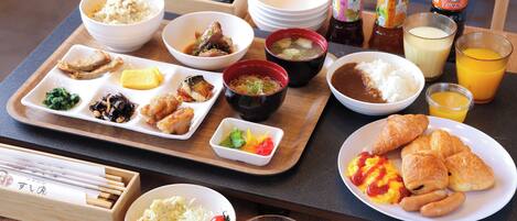 A variety of Japanese dishes on a wooden tray, including rice, soup, and various side dishes.