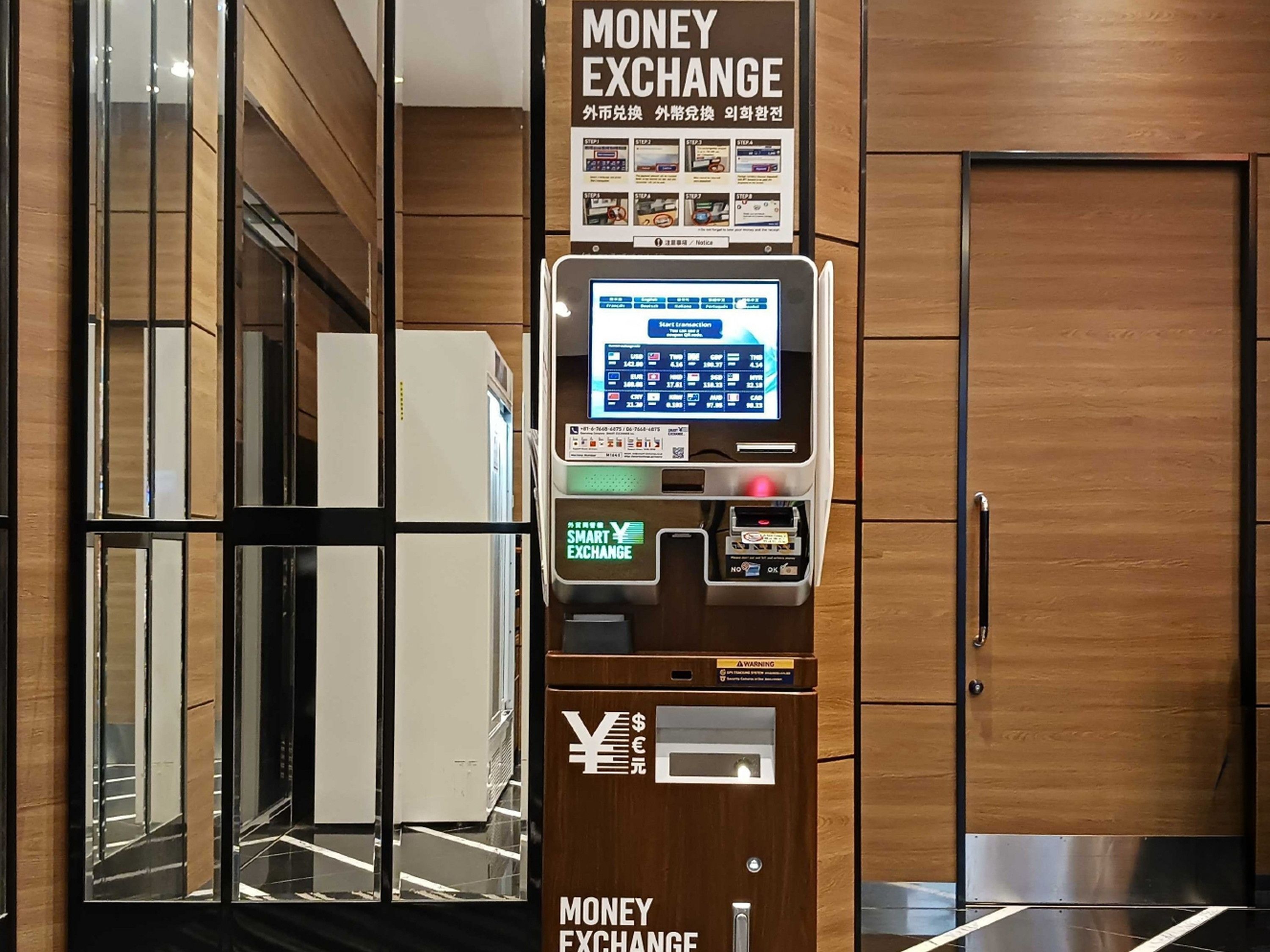 Un cajero de cambio de divisas con pantalla digital, símbolos de moneda y diseño de paneles de madera.