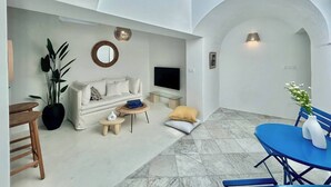 A modern living room with a sofa, TV, and a dining area with a table and chairs. - Zina apartment Sidi Bou Saïd (Sidi Bou Said)