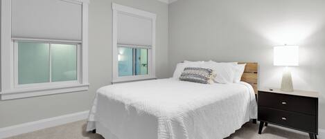 Bedroom 3 features a queen bed and a TV.