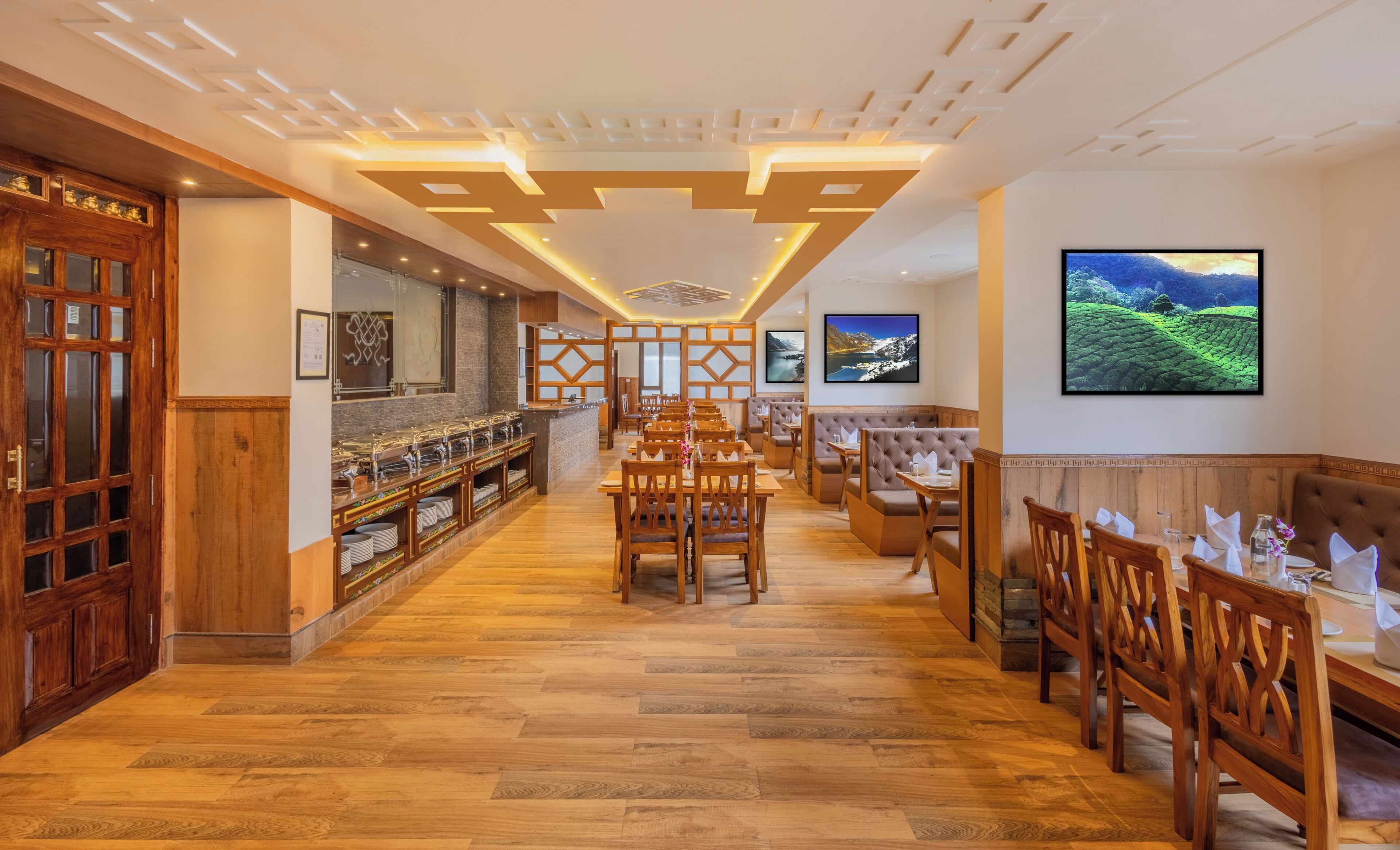 A restaurant with wooden flooring, a buffet area, and a seating area with tables and chairs.