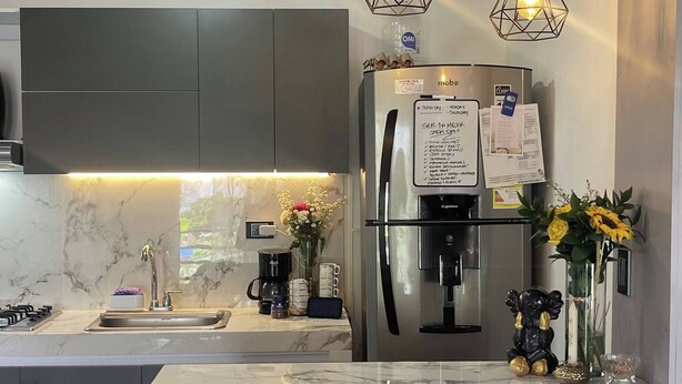 A modern kitchen with a built-in refrigerator, a marble countertop, and pendant lighting. - Luxury Aparment in Chinacota with Studio Perfect for Remote Work (Chinácota)
