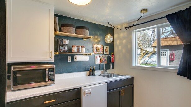A kitchen with a microwave, sink, and cabinets. - Unit 4: Central 1-BR, New Bath, 3 Mi to Dtwn (Spokane)