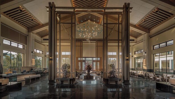 A spacious lobby with a high ceiling, large windows, and a central chandelier. - Steigenberger Icons Guizhou Xiaoqikong (Qiannan)