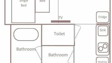 A hotel room layout with single and double beds, a sofa, a table, a TV, a bathroom, a toilet, a fridge, a sink, and a washing machine.