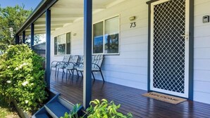 A house with a porch, number 73, and a welcome mat. - Poppi's Paradise - Jervis Bay Escape | Quiet, Modern & Perfect for Families (Sanctuary Point)