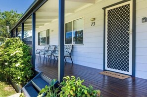 A house with a porch, number 73, and a welcome mat. - Jervis Bay Escape | Quiet, Modern & Perfect for Families (Sanctuary Point)