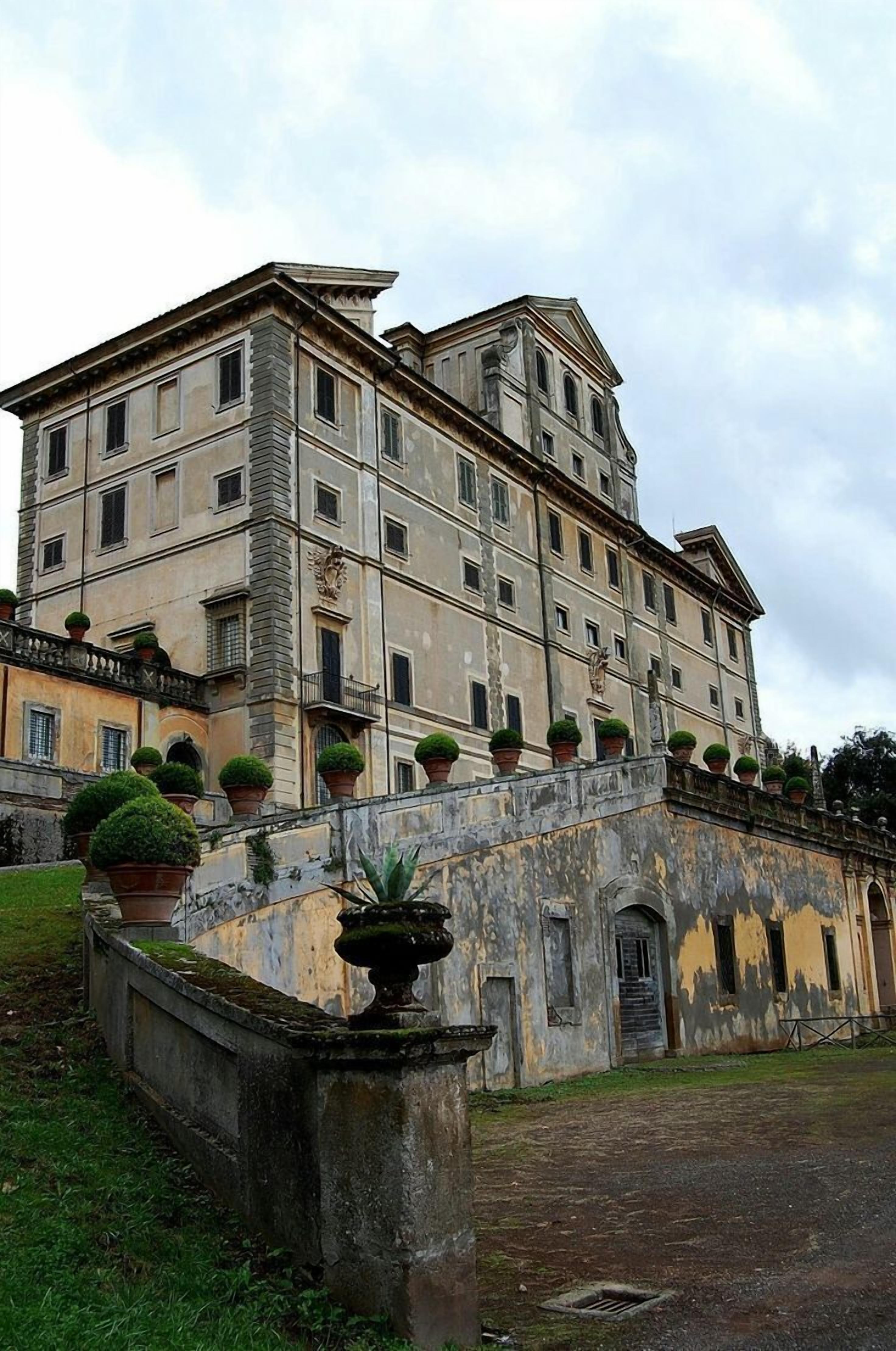 A historic building with multiple stories, a stone facade, and a series of windows.
