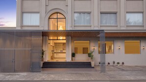 A modern building with a large arched entrance, a covered porch, and a series of windows. - Keys Select by Lemon Tree Hotel Amritsar (Amritsar)
