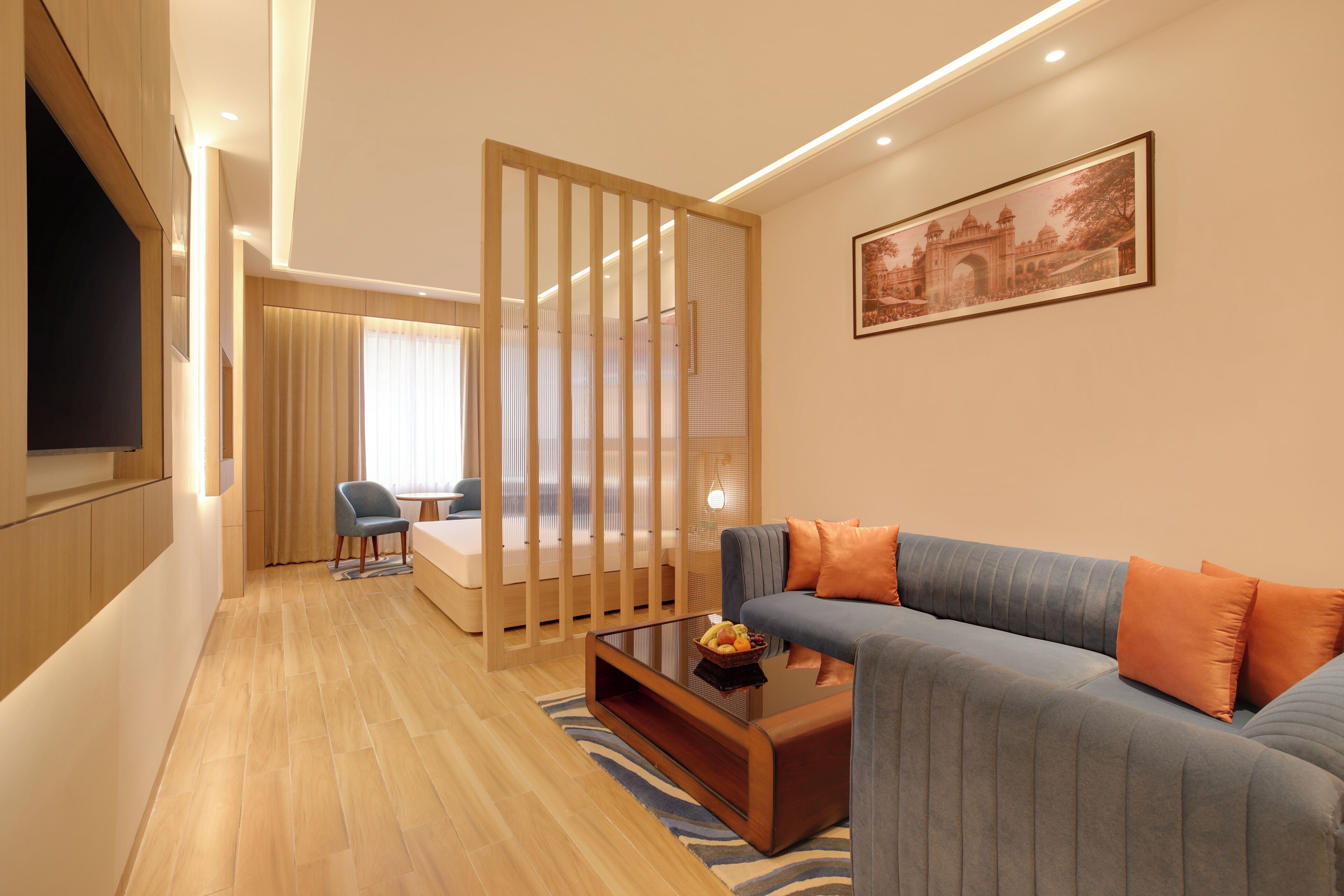 A modern living room with a sofa, coffee table, and a TV.