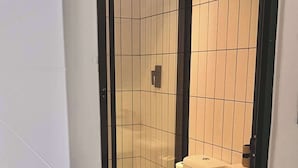 A bathroom with a toilet, sink, and shower area. - Zerilith Haven self catering (Swakopmund)