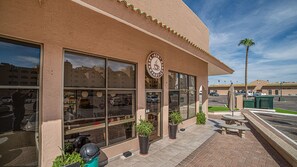 A building with large windows, a sign reading 'Breakfast-Lunch,' and potted plants on the sidewalk. - Sonoran Spa E-204 – Coastal Escape with Private Oceanfront Patio (Puerto Peñasco)