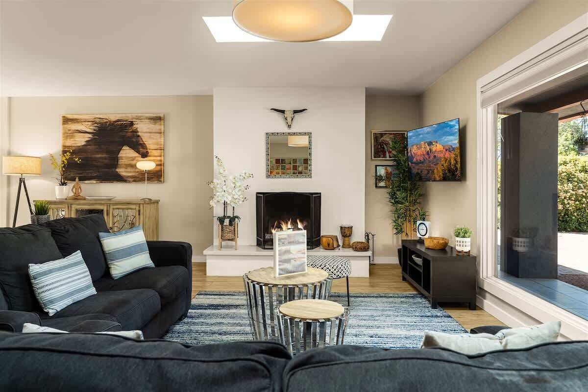 A living room with a fireplace, a sofa, a coffee table, and a TV.