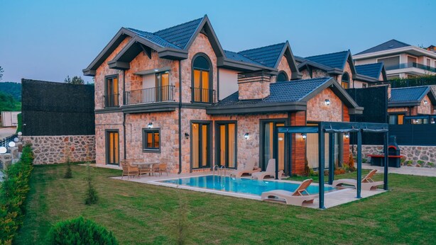 A two-story house with a swimming pool, outdoor seating, and a covered patio area. - Selvi Lİfe Villa (Sapanca)