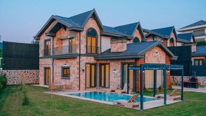A two-story house with a swimming pool, outdoor seating, and a barbecue area. - Selvi Lİfe Villa (Sapanca)
