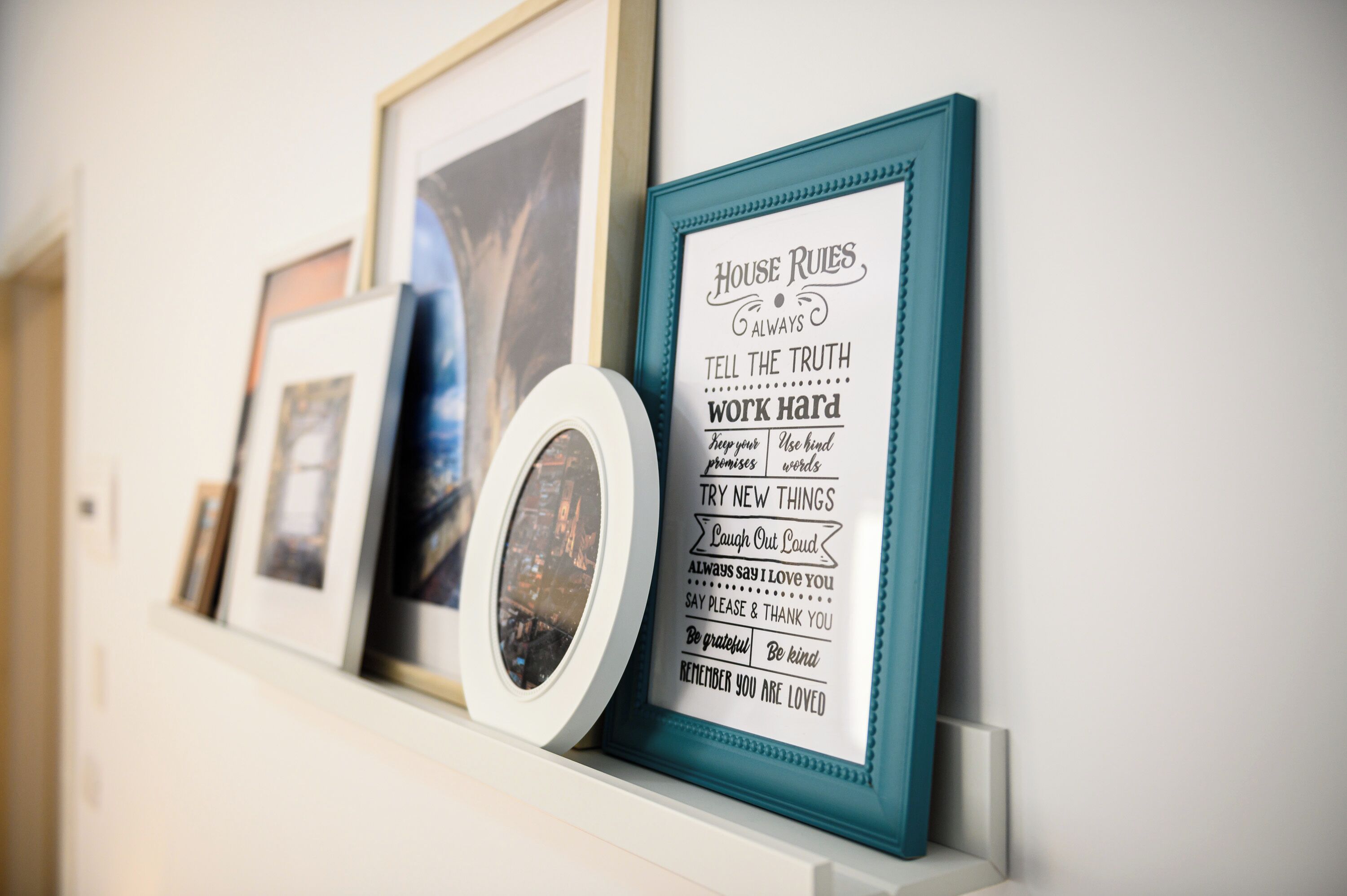 Un mur orné d’une série d’objets encadrés, dont un panneau affichant le règlement intérieur.