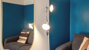 A room with a large mirror, two armchairs, and a floor lamp. - Via Galiani 20 (Naples)