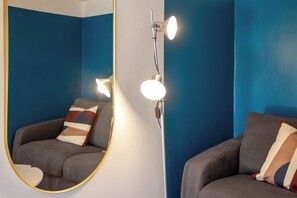 A room with a large mirror, two armchairs, and a floor lamp. - Via Galiani 20 (Naples)