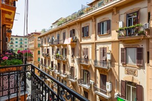 A row of multi-story buildings with balconies, some with potted plants. - Via G. A. Pasquale 16 (Naples)