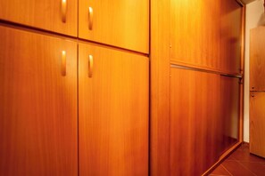 A wooden wardrobe with a sliding door and a small door to the right. - Il Nido (Naples)