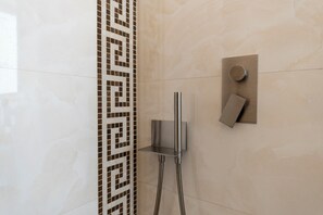 A shower area with a modern design, including a wall-mounted faucet and a square-shaped control panel. - Via Concezione a Montecalvario 19 (Naples)