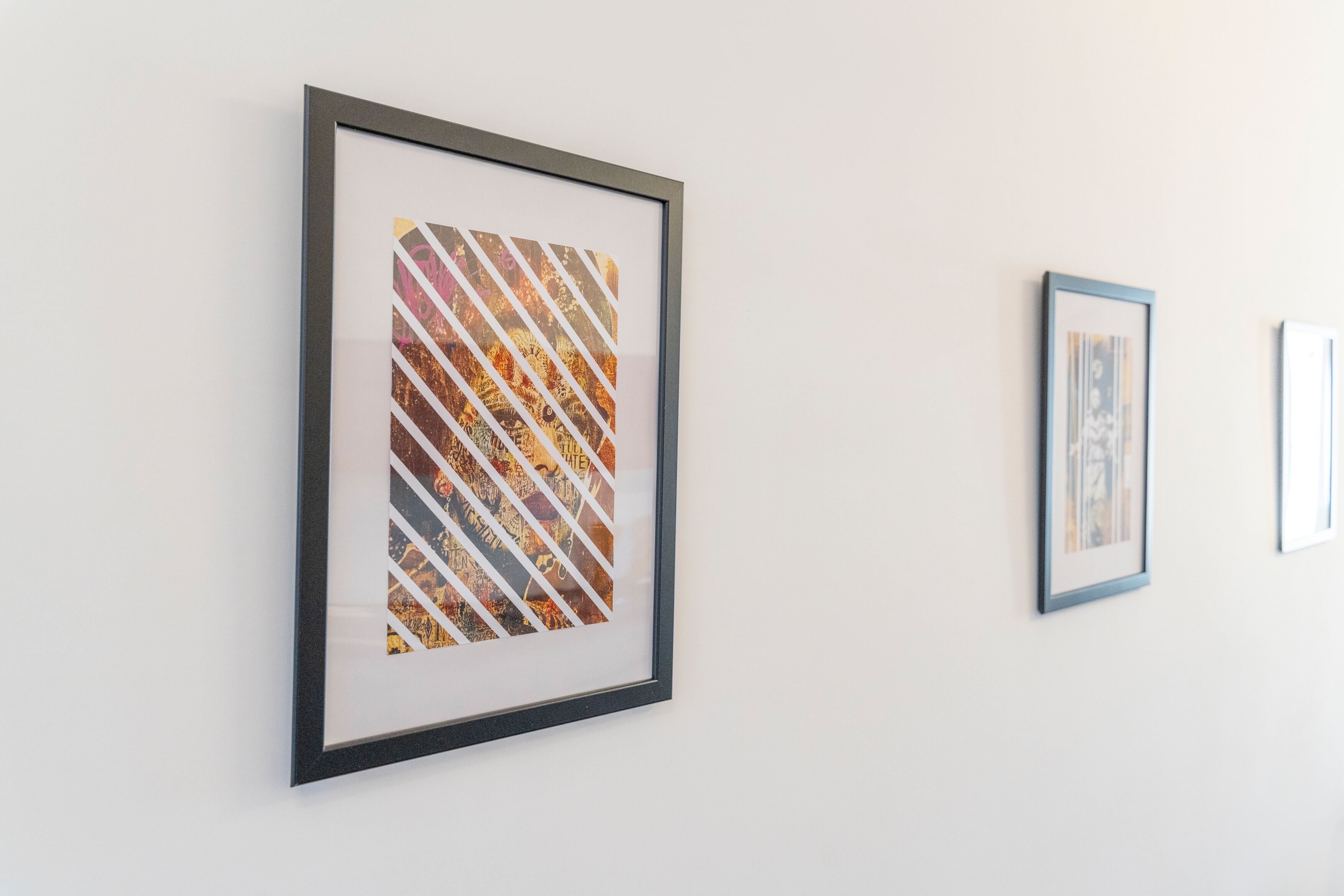A framed artwork on a wall.