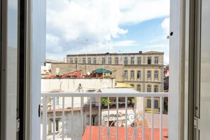 A view from a balcony with a railing, overlooking a street with buildings and a clear sky. - Vico Santa Maria del Pozzo 9 (Naples)