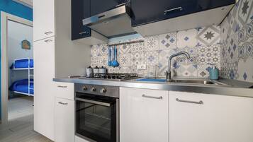 Apartment (1 Bedroom) | Private kitchen | Oven, stovetop, electric kettle, cookware/dishes/utensils