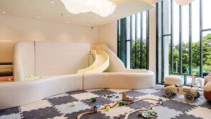 A children's play area with a slide, a play mat, and toy vehicles. - Title Legendary by Villacarte (Choeng Thale)