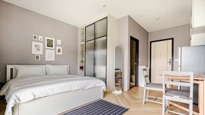 A modern bedroom with a bed, a desk, a chair, and a large mirror. - Title Legendary by Villacarte (Choeng Thale)