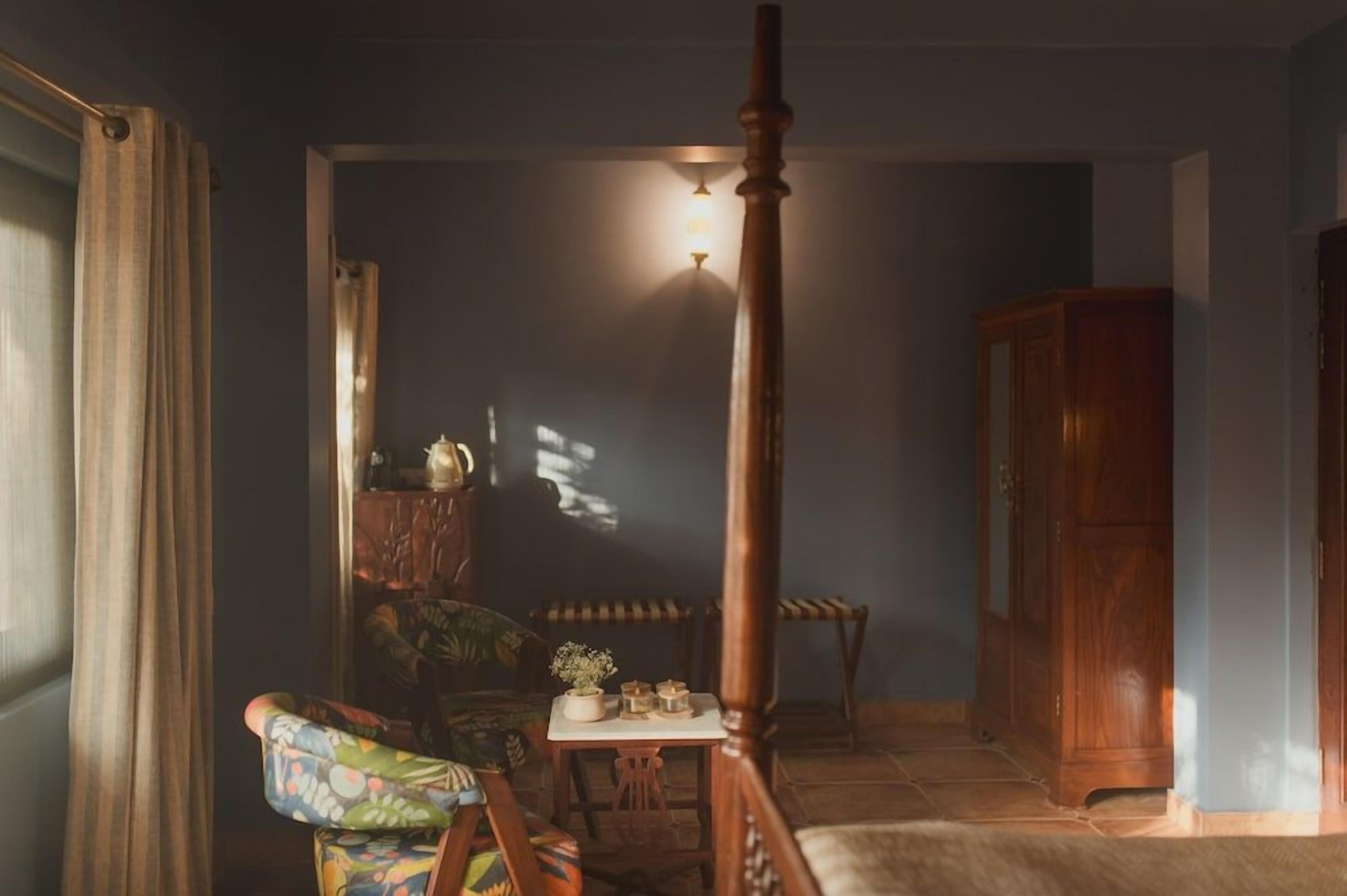 A room with a wooden chair, a small table, and a cabinet.