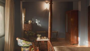 A room with a wooden chair, a small table, and a cabinet.