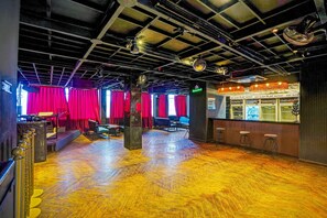 An interior with a bar area, red curtains, and a wooden floor. - Palette Hotel and Resorts Jodhpur (Jodhpur)