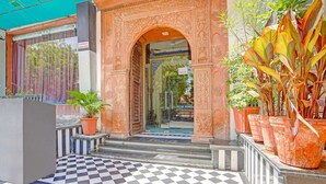 A hotel entrance with an ornate archway, checkered floor, and potted plants. - Palette Hotel and Resorts Jodhpur (Jodhpur)
