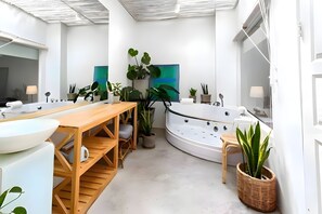 A modern bathroom with a wooden vanity, a large bathtub, and various potted plants. - Naptel Changmoi (Chiang Mai)
