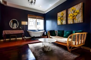 A modern living room with a sofa, a round coffee table, a bathtub, and a large window. - Naptel Changmoi (Chiang Mai)