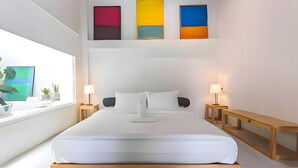 A modern bedroom with a large bed, bedside tables, a window with plants, and colorful artwork on the wall. - Naptel Changmoi (Chiang Mai)