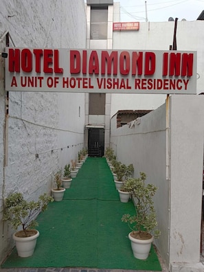 Ein Hotel Eingang mit einem Schild, auf dem 'HOTEL DIAMOND INN A UNIT OF HOTEL VISHAL RESIDENCY' steht.