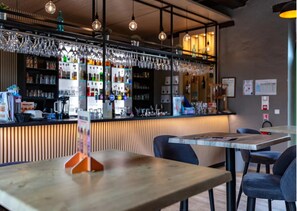 A bar area with a counter, hanging glasses, and a menu stand. - COTTAGE PARKS LA FORÊT - 3 bed 6 bath mobile home in the heart of the chateau park (Saint-Julien-des-Landes)
