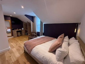 A bedroom with a large bed, a desk, a chair, and a small closet. - Auberge (Lytham St. Anne's)