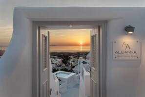 A view from a traditional villa with a sign reading "ALEANNA TRADITIONAL VILLA" and a sunset in the background. - Aleanna Traditional Villa @ Fira 3-bedroom-3 bathroom (Thera Fira)