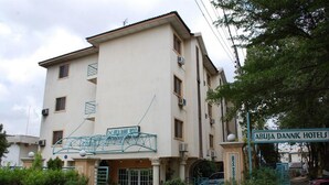 A multi-story building with a sign for 'ABUJA DANNIC HOTELS' and a metal staircase leading to the entrance. - Room-abuja Dannic Hotels - Guest Room (Abuja)